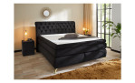 Boxspringbett Saragossa in einem samtähnlichen Stoff in schwarz, in einem Raum stehend