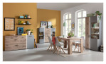 Highboard LIV'IN Baveno in Nox Oak und hellgrau und Glasausschnitten an den Türen. Auf einem dekorierten Hintergrund.
